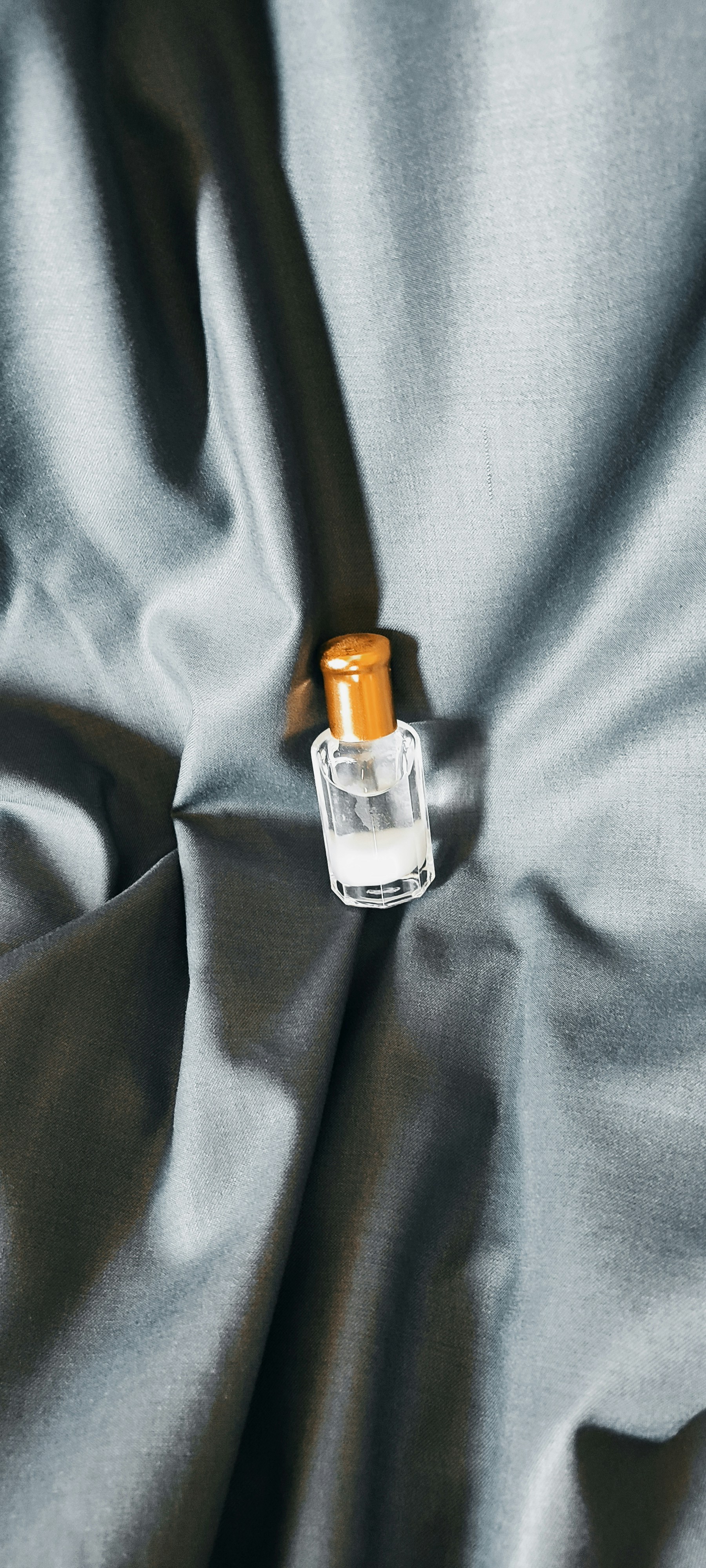 a bottle of alcohol on a bed