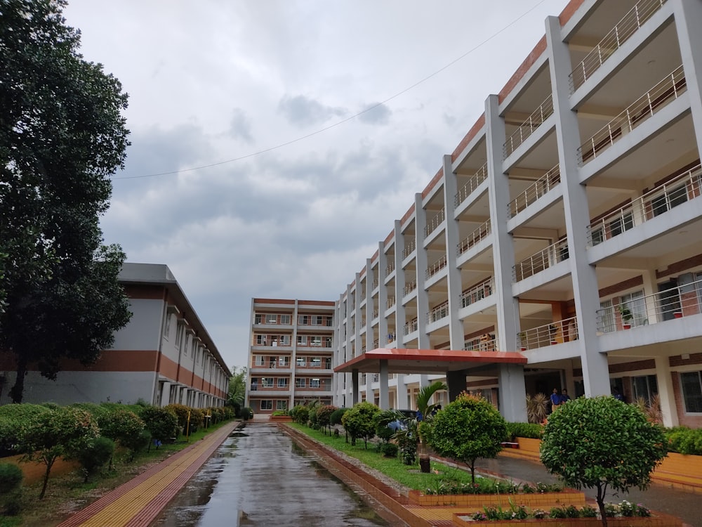 a building with a walkway and trees