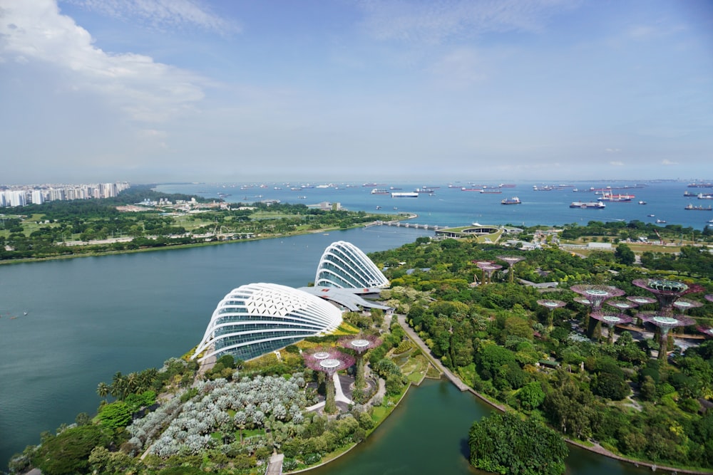 a building with a glass roof by a body of water