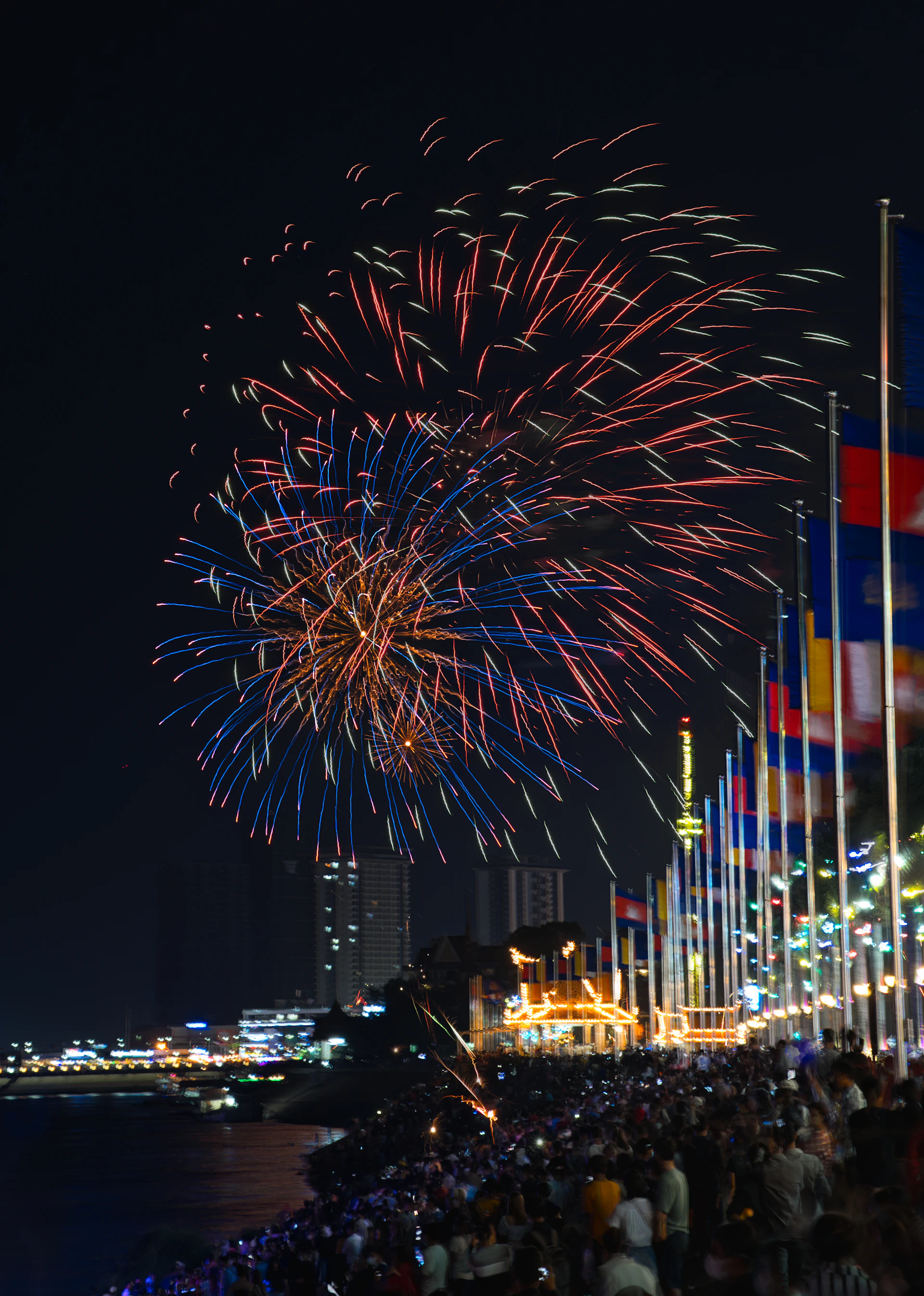 A festive scene from the 4th of July event, with colorful fireworks illuminating Boston’s skyline and crowds enjoying the celebration.