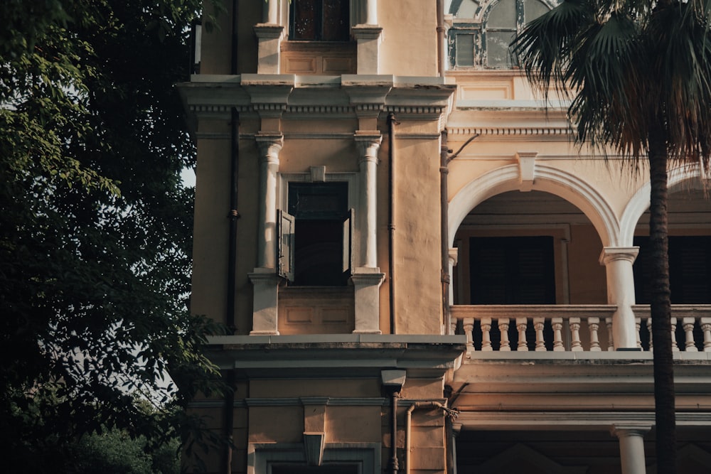 a building with columns and a tree