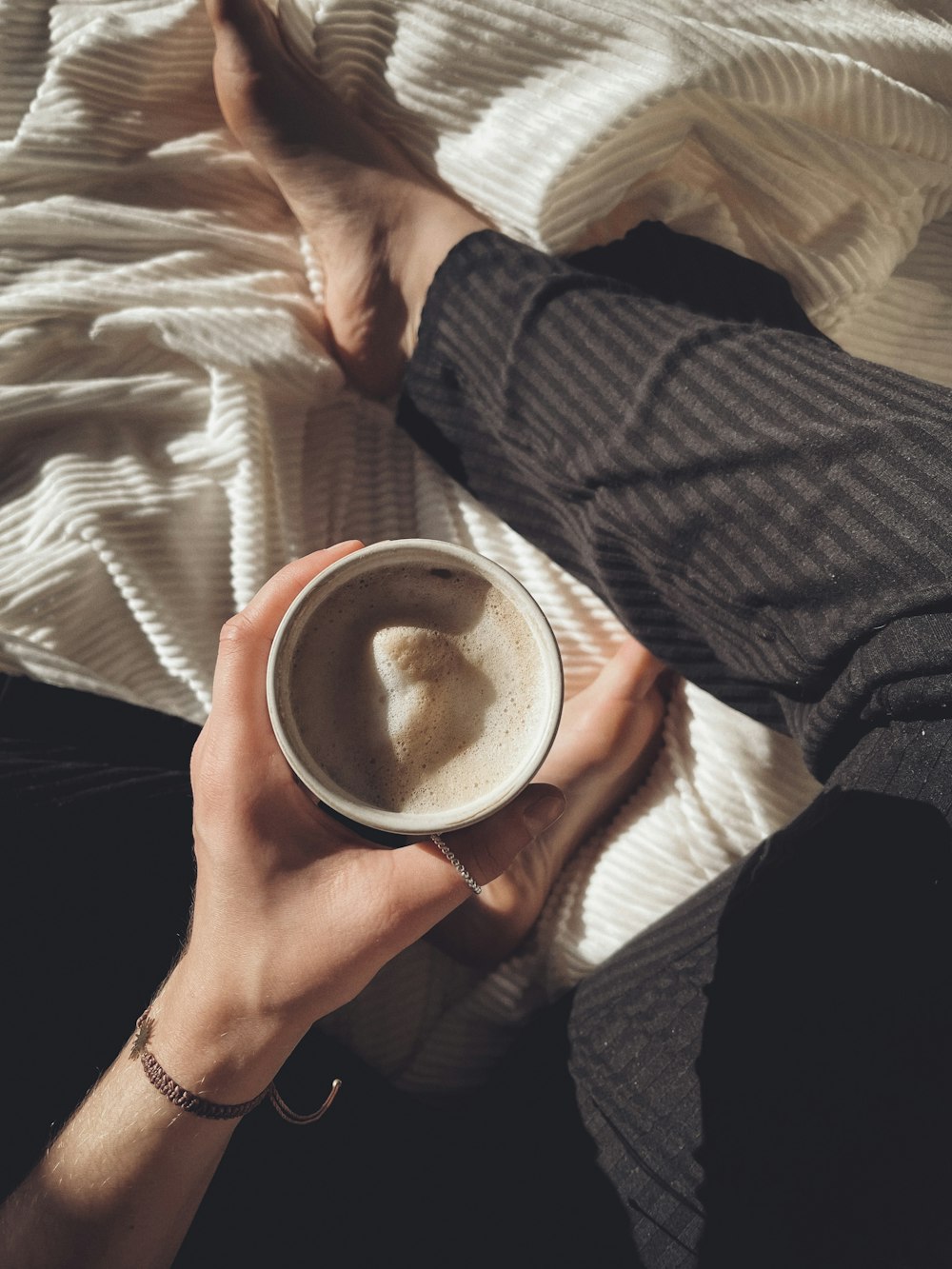 a person holding a cup of coffee