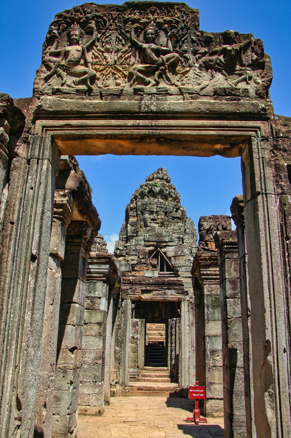 a stone building with a large statue on top