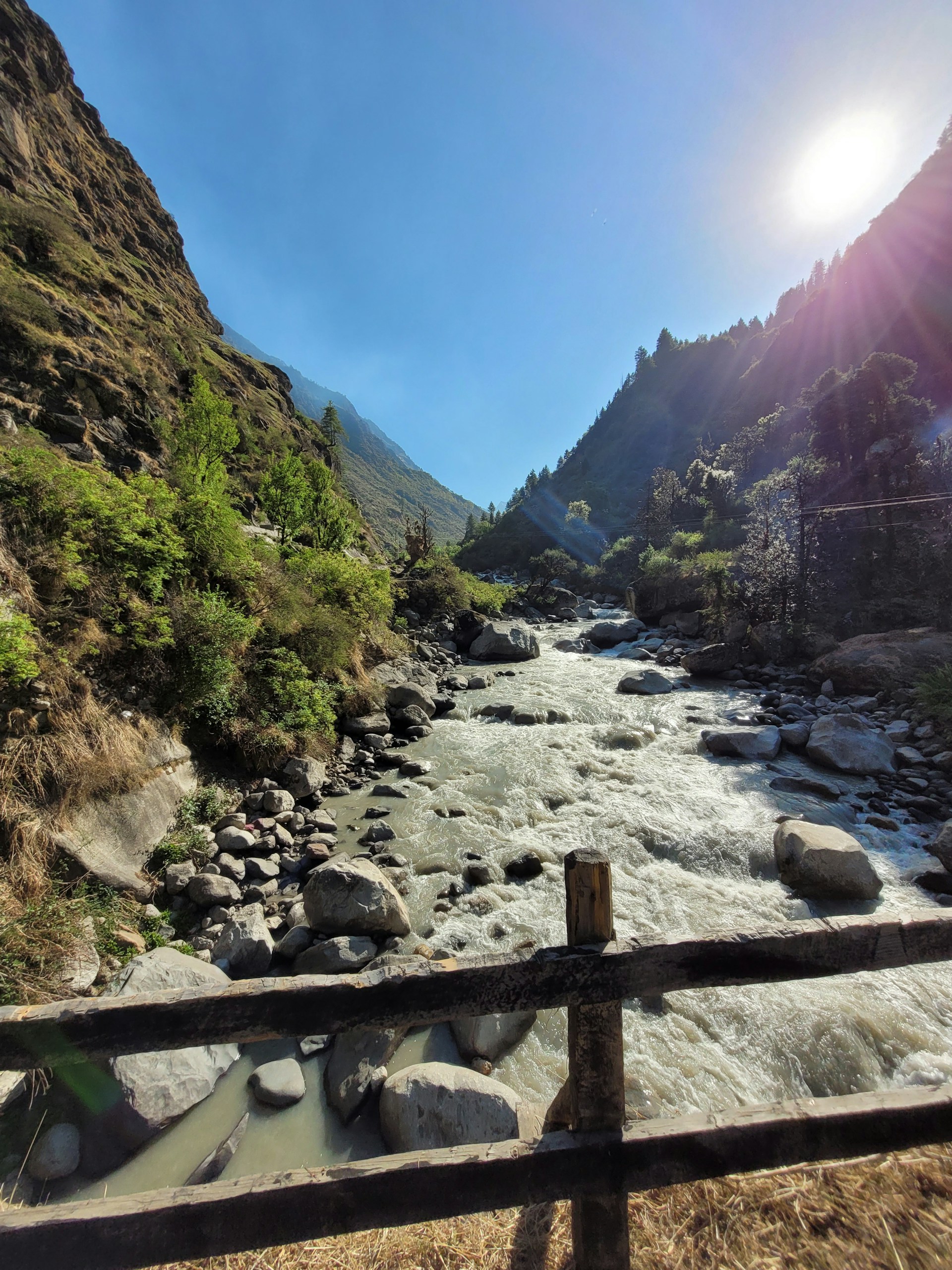 a river running through a valley between mountains