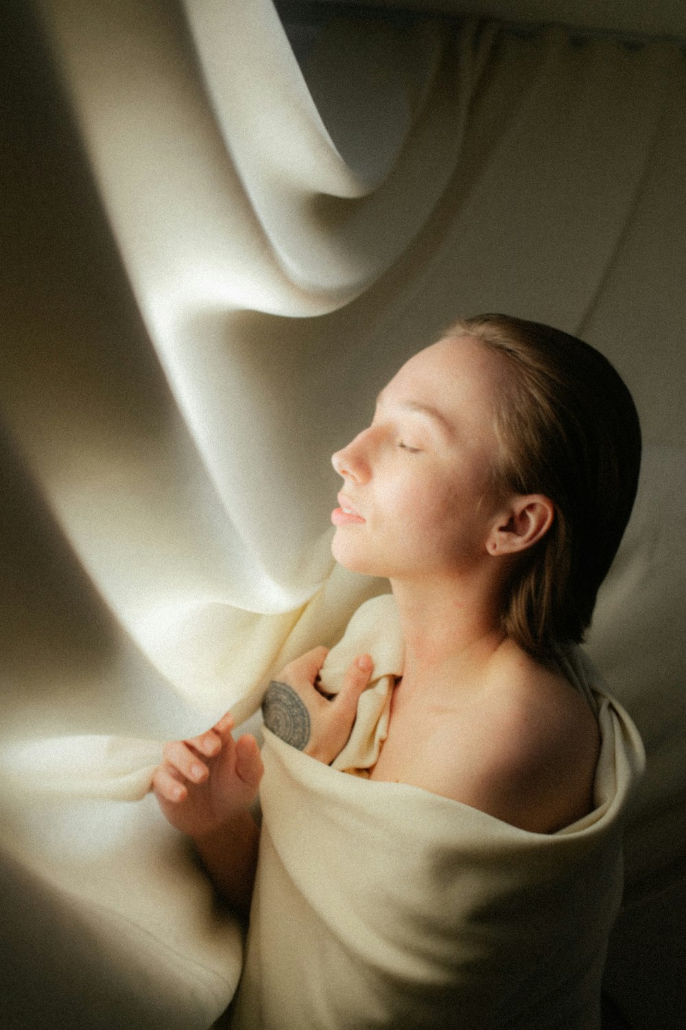 a young girl sitting on a bed