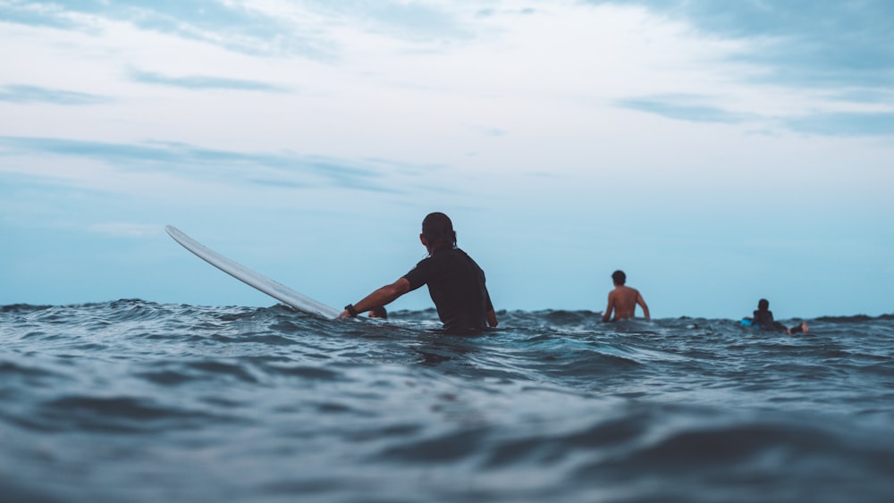 a girl riding a wave on a surfboard in the water