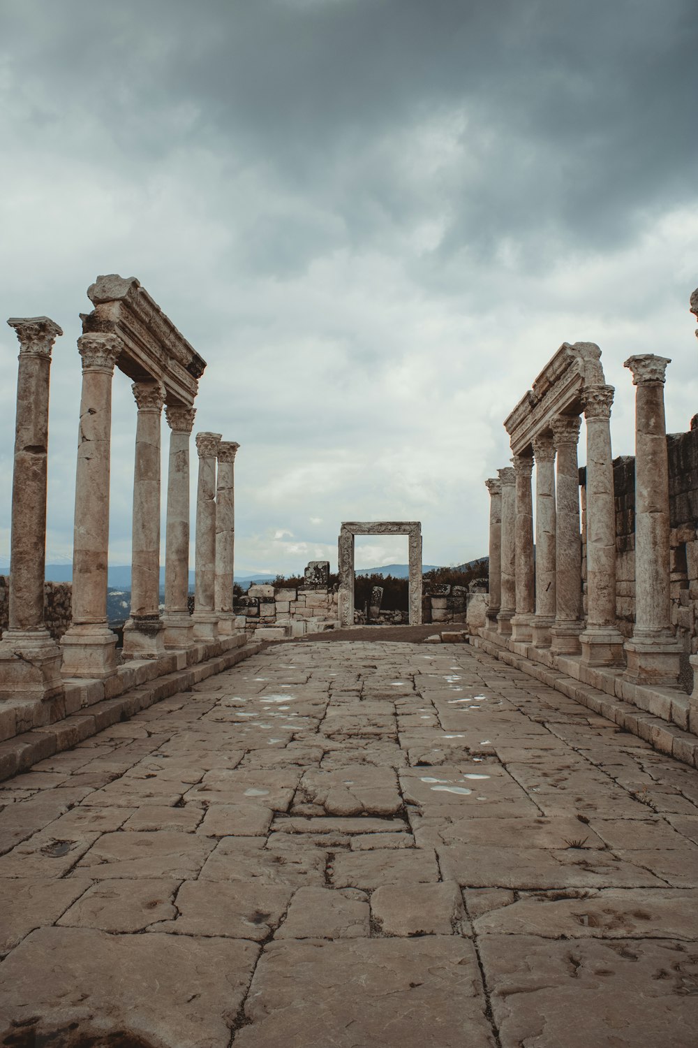 a stone walkway with pillars