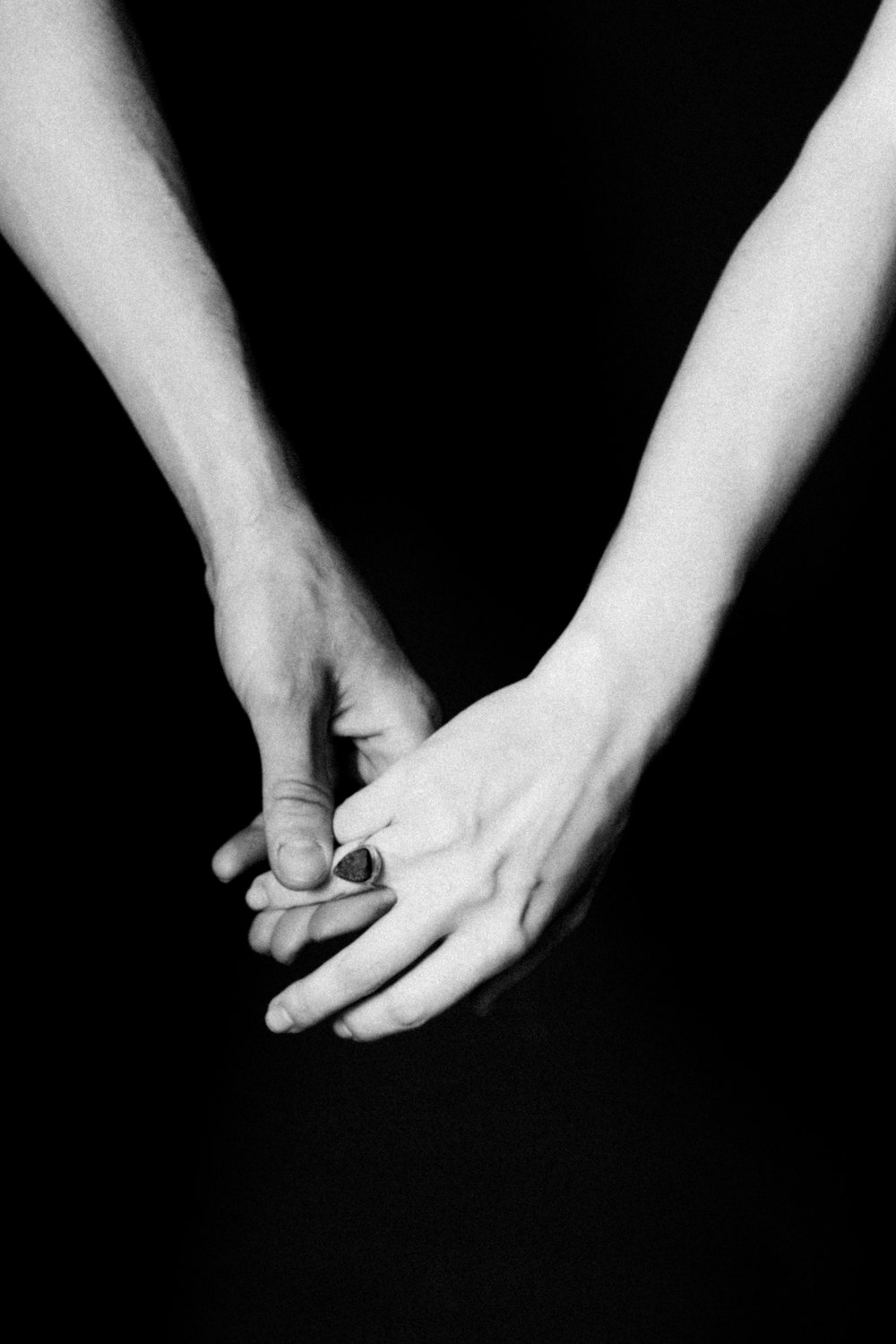 a close-up of a hand holding a baby's hand