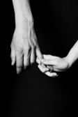 Close-up of intertwined fingers symbolizing trust and partnership.