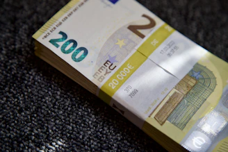 Stacked counterfeit euro bills with visible disclaimers printed on each note.