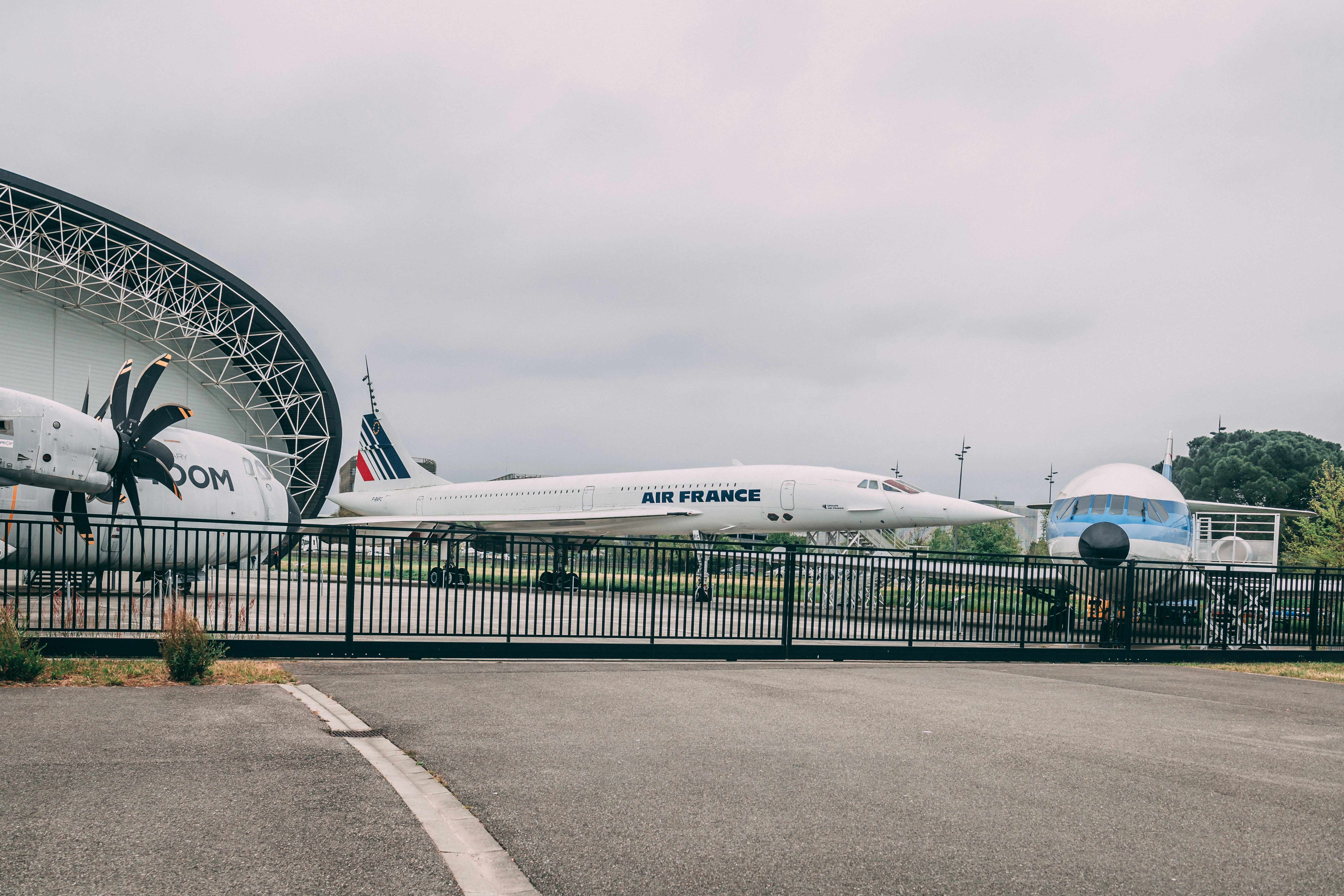 a large white airplane sits on a runway, 