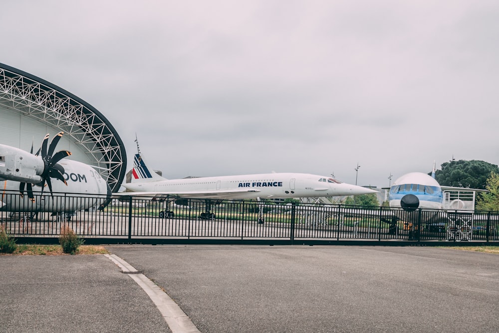 a large white airplane sits on a runway