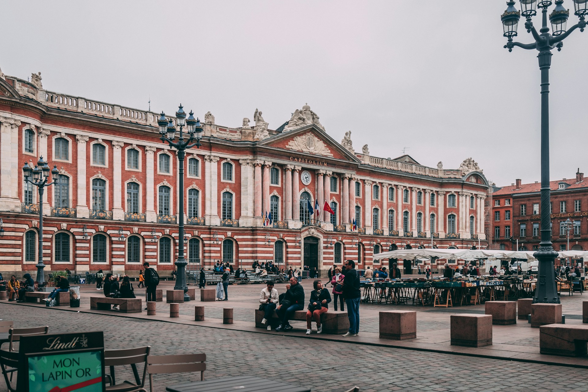 a large building with many windows with Capitole de Toulouse in the background