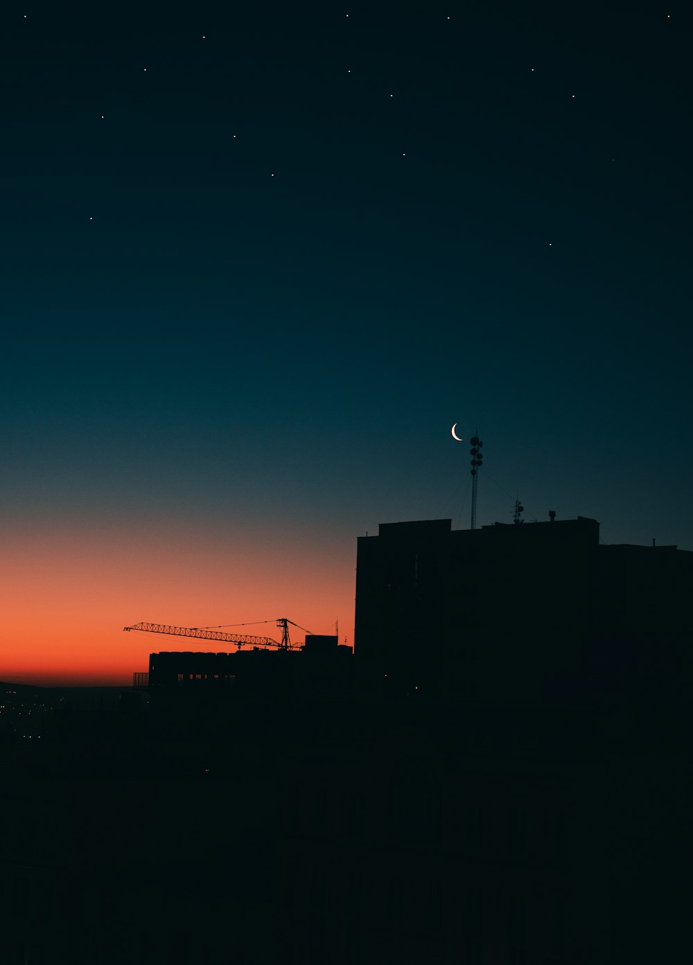a silhouette of a building and a sunset