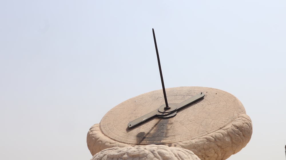 a wooden clock on a rock