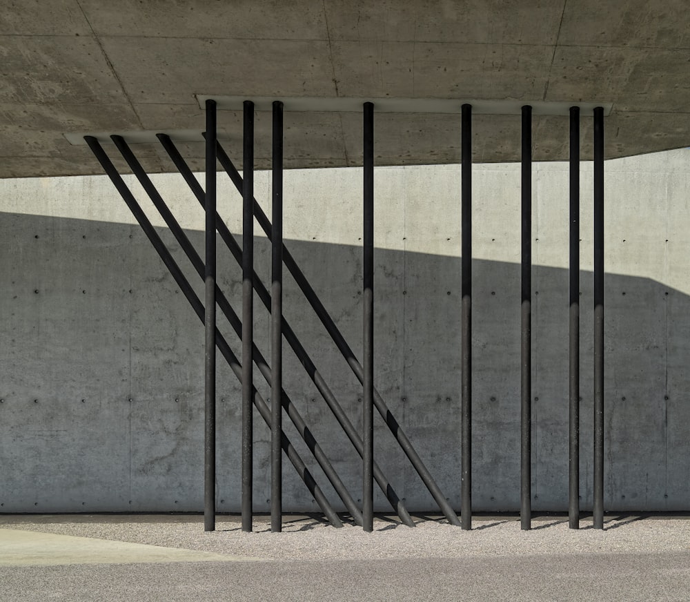 a black and white photo of a wall with a metal gate