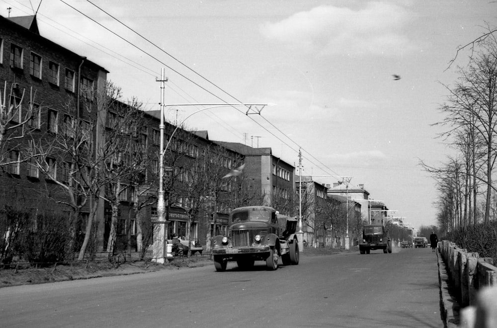 a group of trucks travel down a street