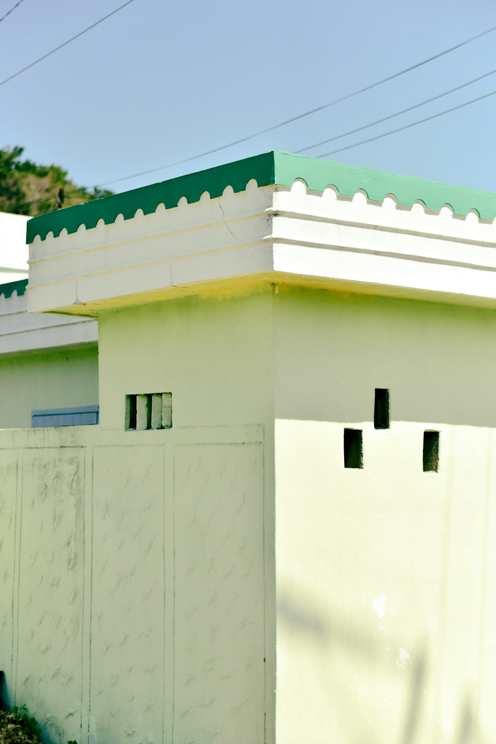 a white building with green roof