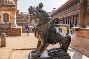 a statue of a person riding a horse