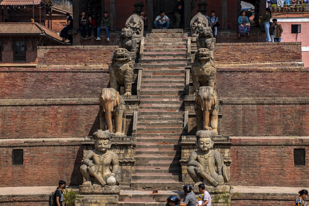 a group of statues on a brick building