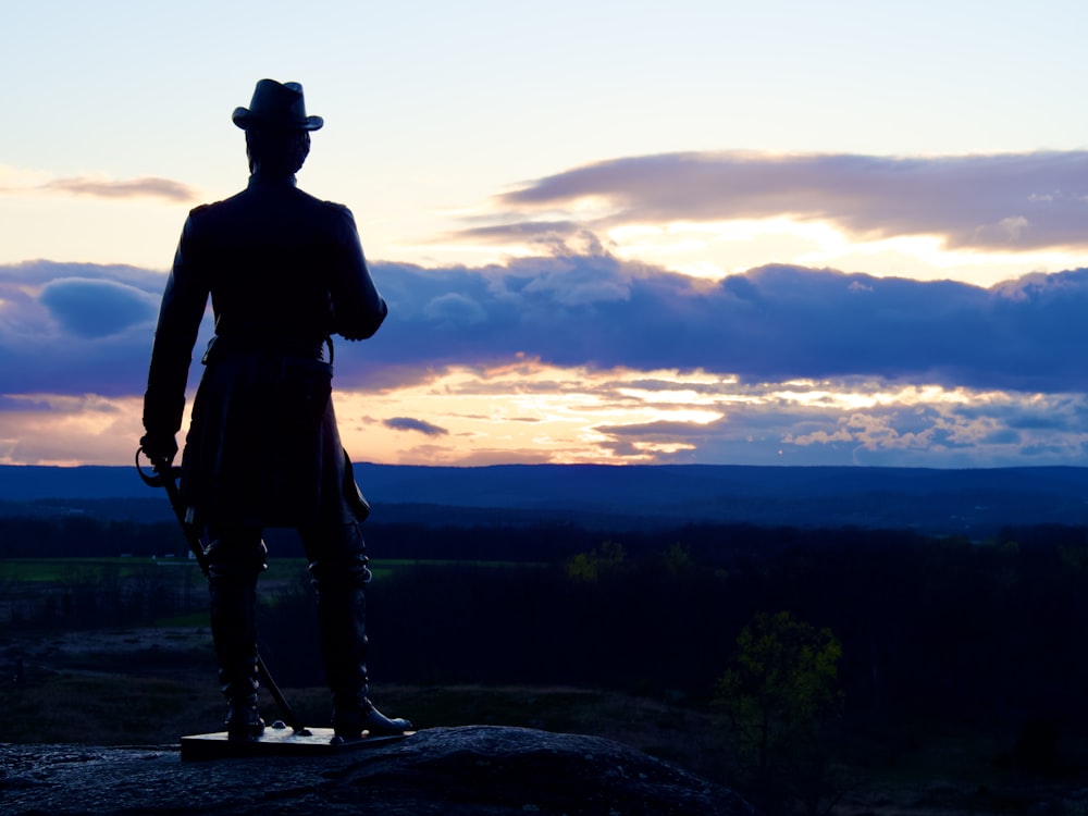 a statue of a man with a hat and a cane