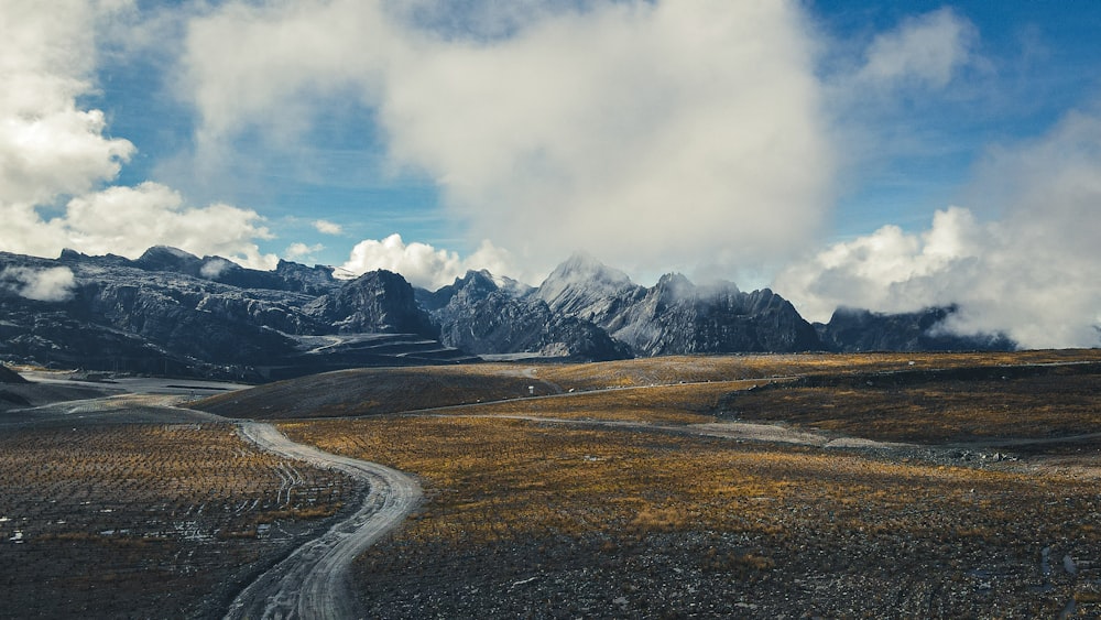 a road leading to a mountain range