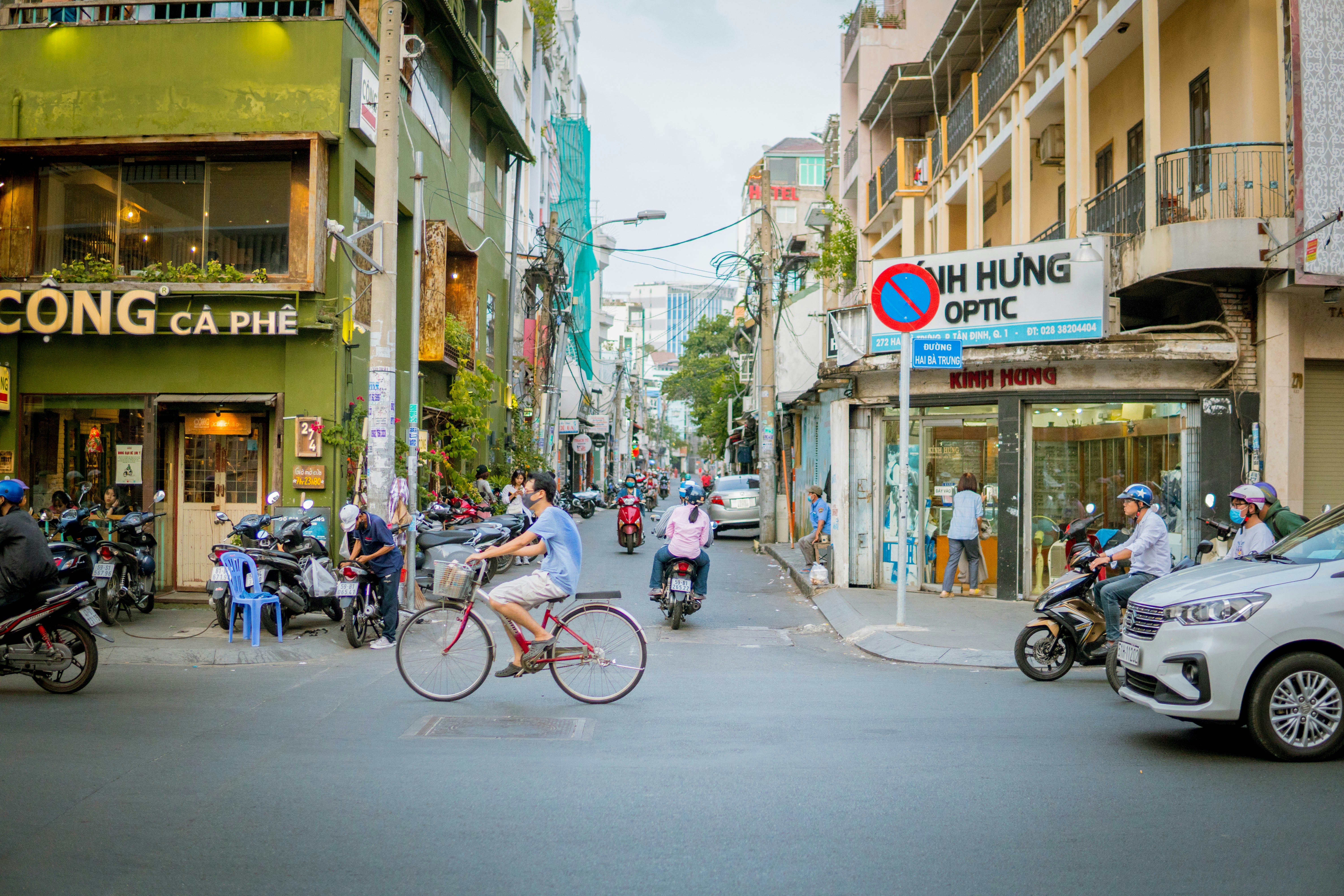 a group of people riding bikes down a street