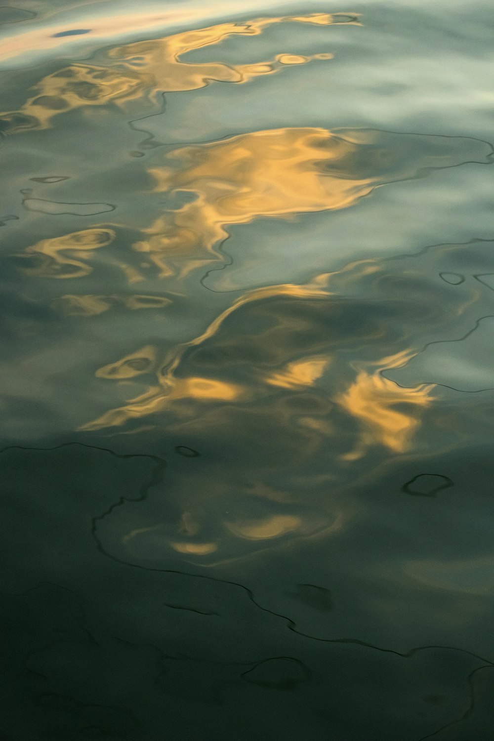 a body of water with clouds above it