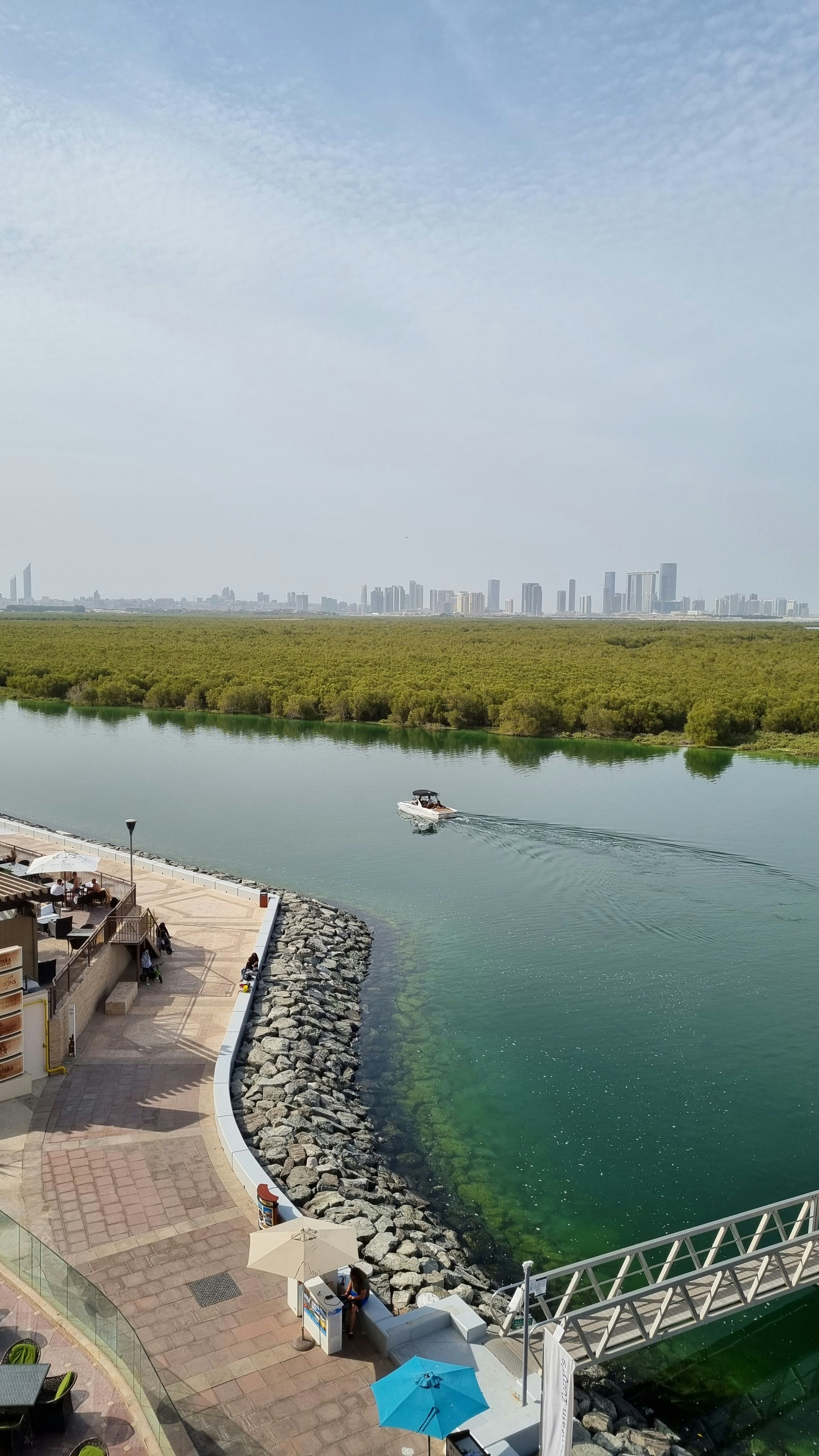 a body of water with a boat in it and a city in the background