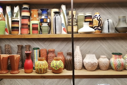 a shelf is filled with vases