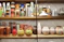 a shelf is filled with vases