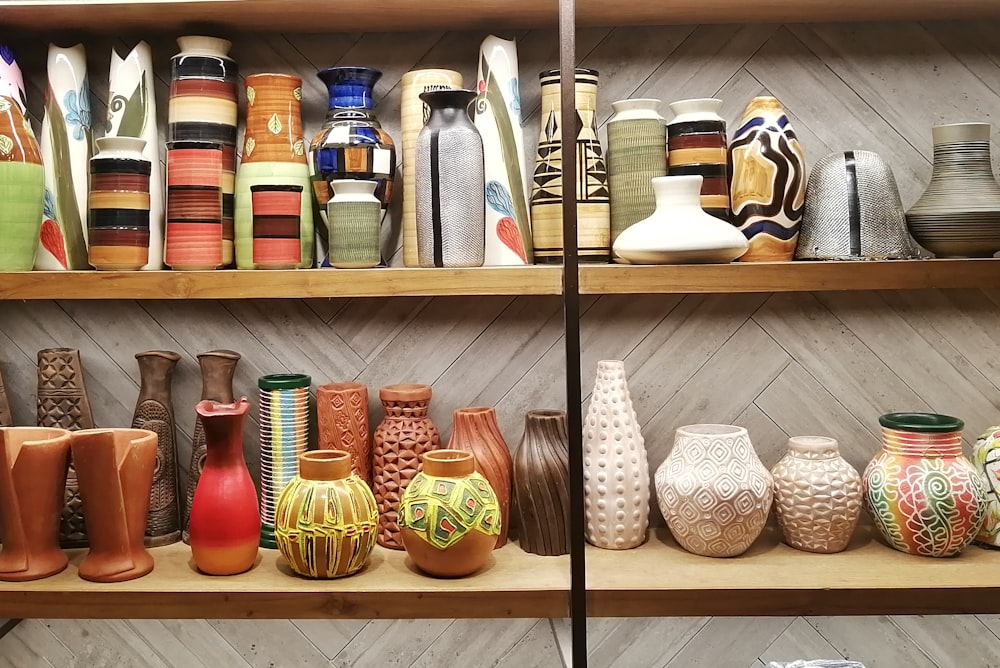 a shelf is filled with vases