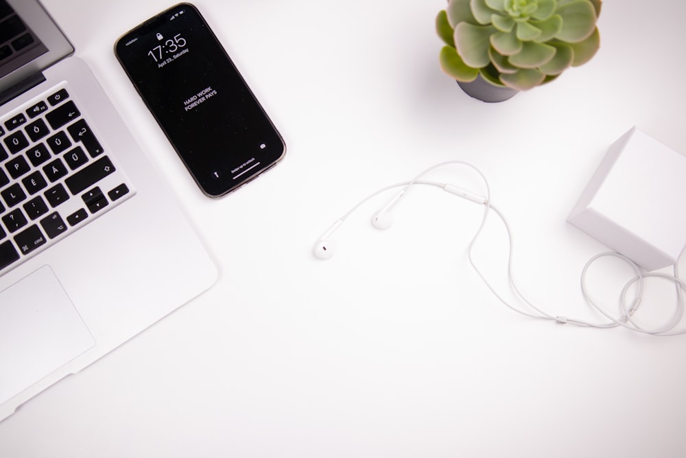 a white table with a laptop and a white cord