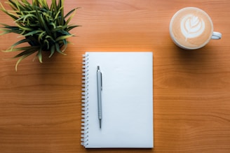 a pen and a cup of coffee