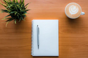 a pen and a cup of coffee