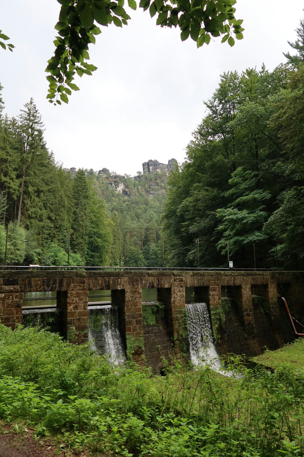 a waterfall over a stone wall