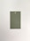 A rectangular paper card with a hole at the top center placed on a neutral, light background. The card is a muted green color.