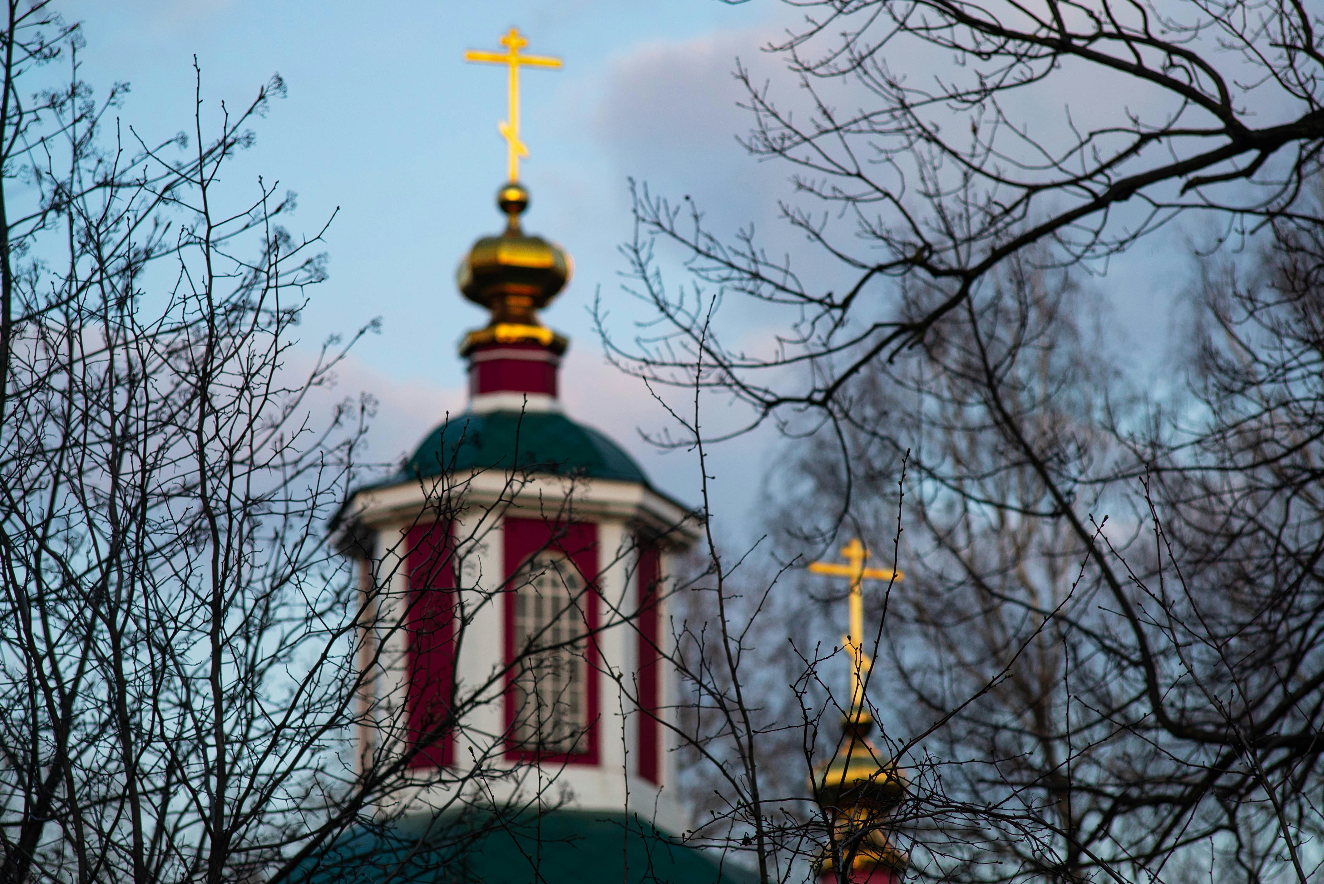 a small building with a gold cross on top