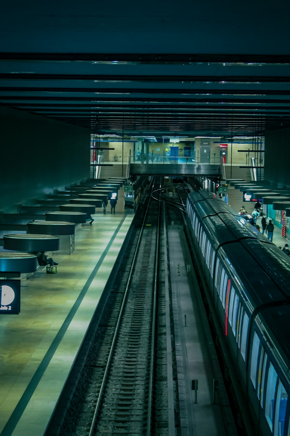 a train station with people waiting