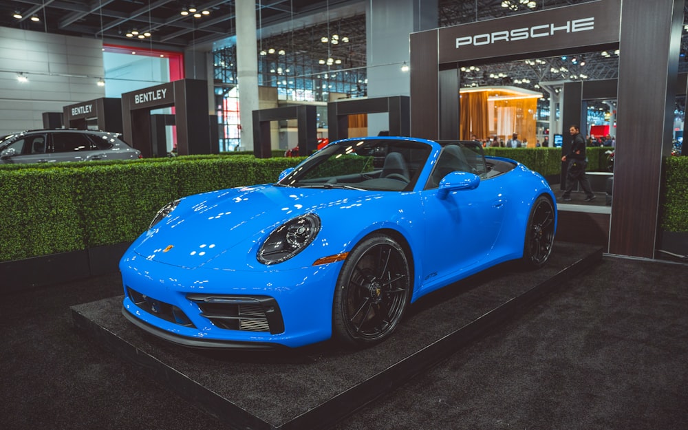 a blue sports car parked inside a building