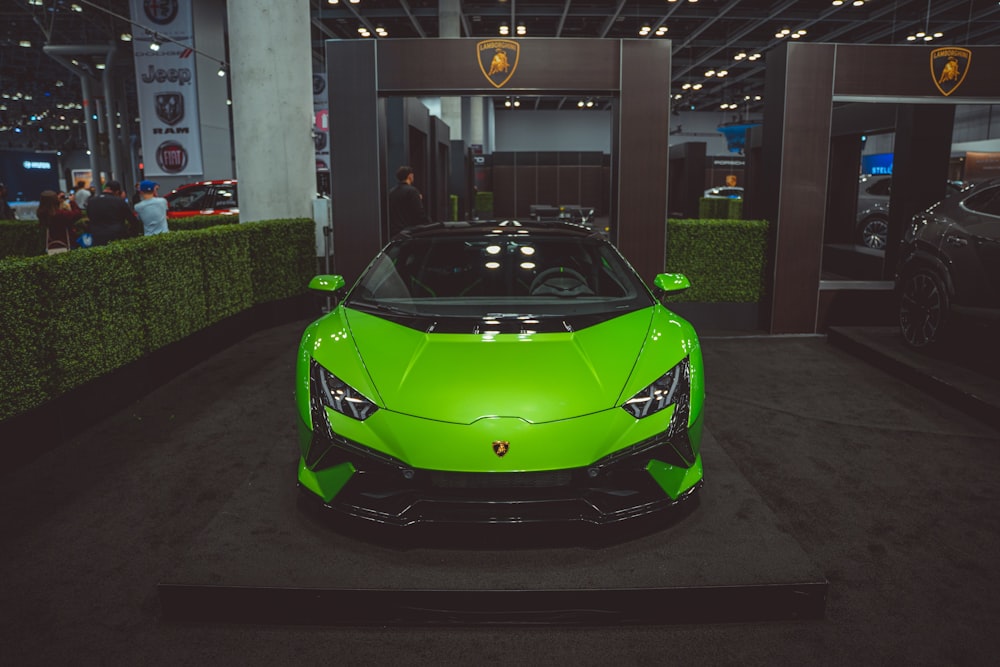 a green sports car parked in a building