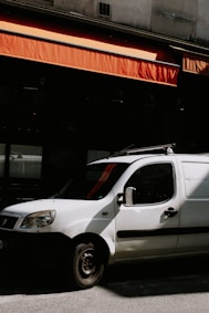 a white car parked in front of a building