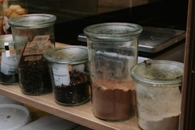 a group of jars with food in them