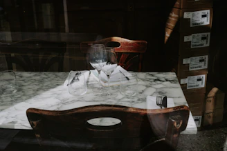 Elegant marble dishes arranged on a rustic wooden table, showcasing smooth finishes.