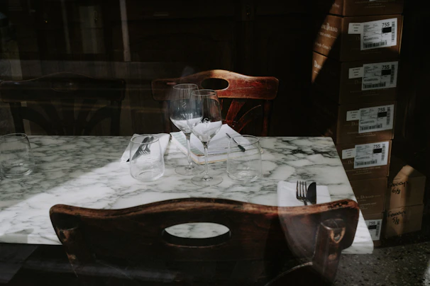 Elegant marble dishes arranged on a rustic wooden table, showcasing smooth finishes.