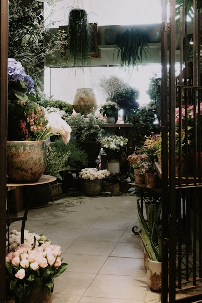 A vibrant display of fresh natural flowers and plants arranged beautifully in a cozy indoor setting.