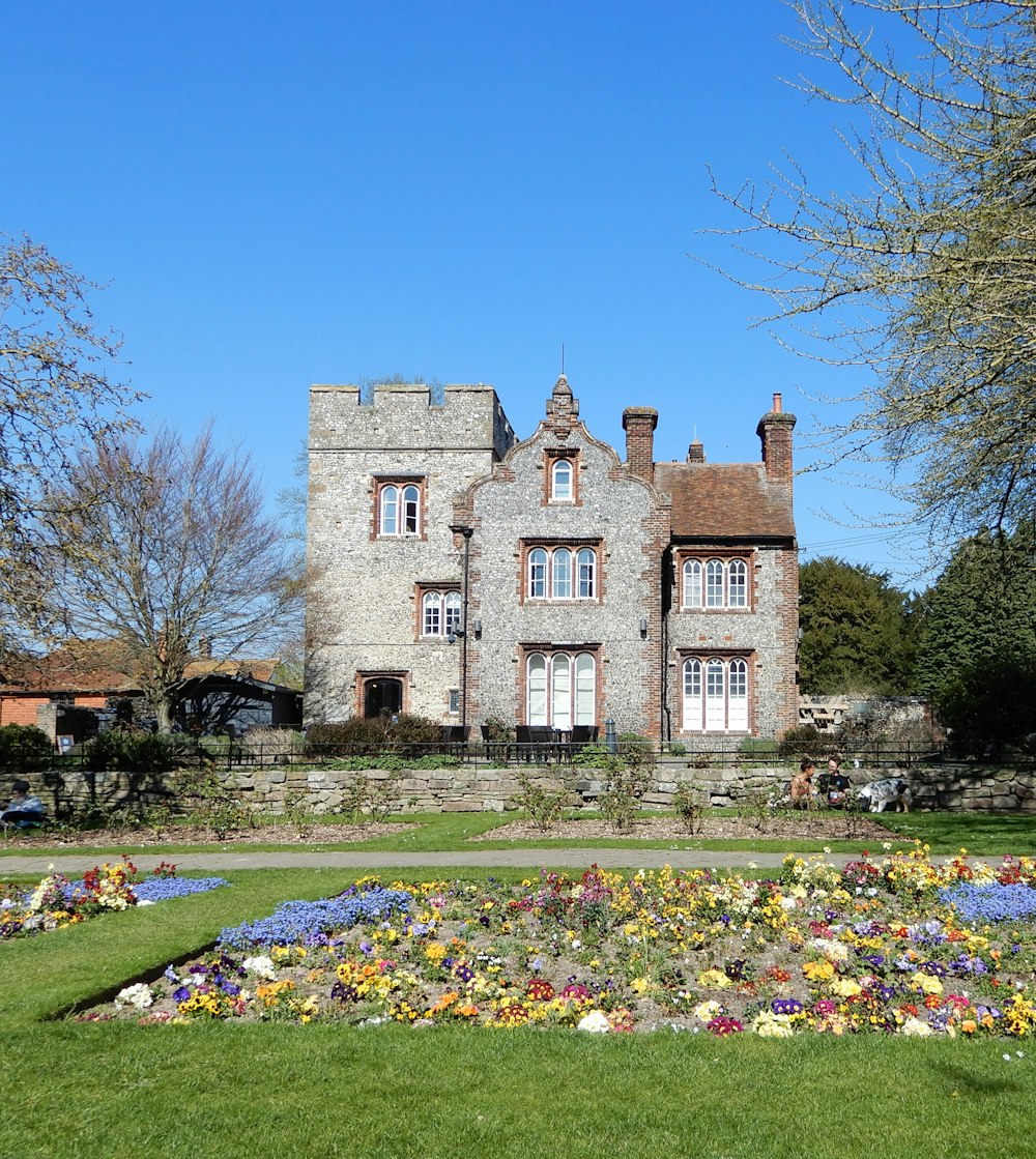 a large brick house with a garden in front of it