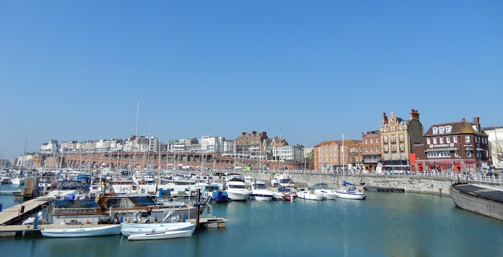 a body of water with boats in it and buildings in the back