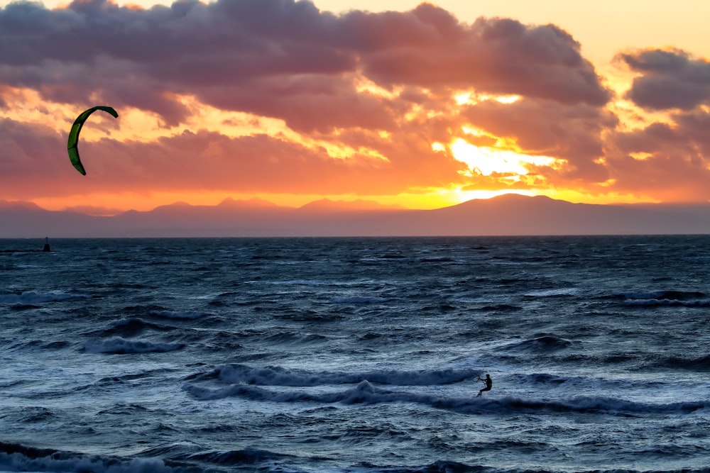 a person parasailing on the ocean