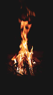 Bright flames flickering over a coffee roaster, illustrating the fire phase.